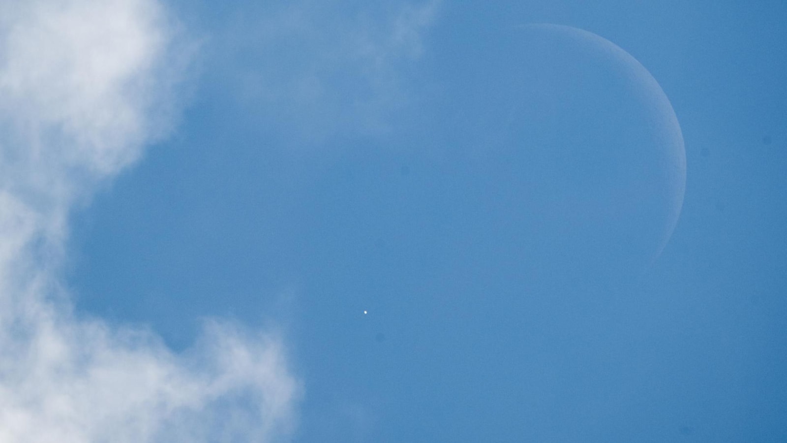 Venus is seen as it disappears behind the Moon at the start of the occultation on June 17, 2026, from the Mary W. Jackson NASA Headquarters building in Washington.