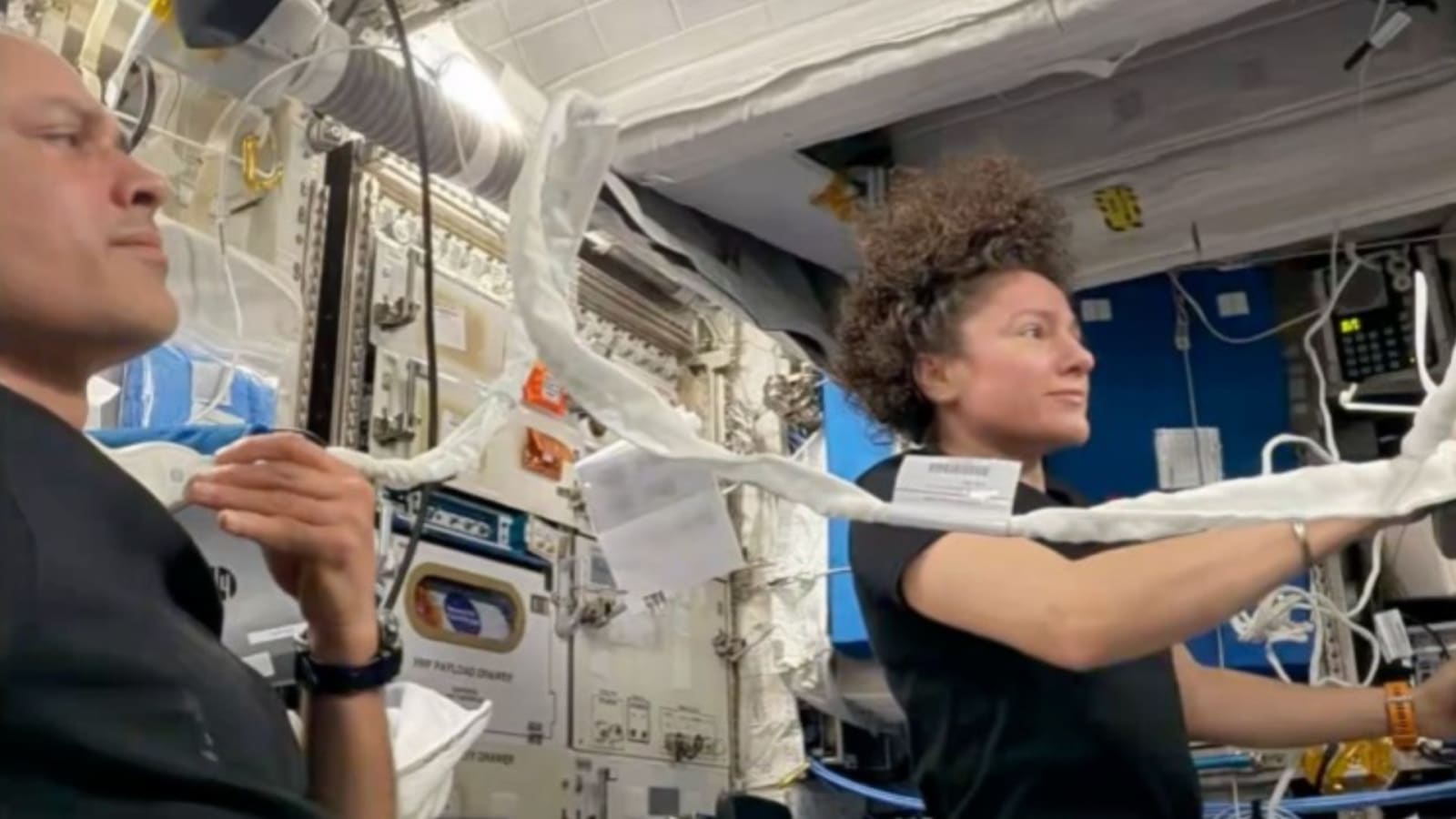 NASA astronauts Anil Menon (L) and Jessica Meir performing ultasound aboard the ISS.