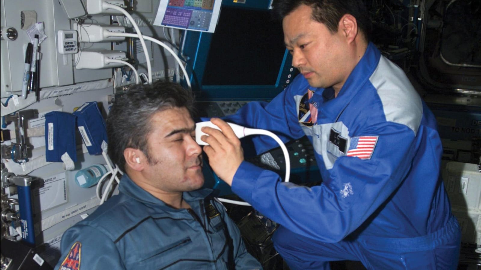 NASA astronaut Leroy Chiao performs an ultrasound examination of the eye on cosmonaut Salizhan Sharipov using ADUM protocols.