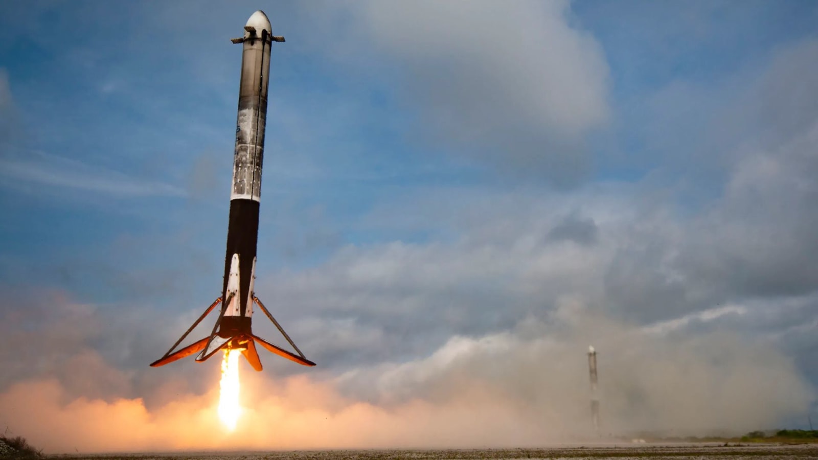 Side boosters of SpaceX's Falcon Heavy land at the company’s landing zone at Cape Canaveral Space Force Station in Florida on Friday, Oct. 13, 2023, just minutes after NASA’s Psyche launch from Kennedy Space Center.