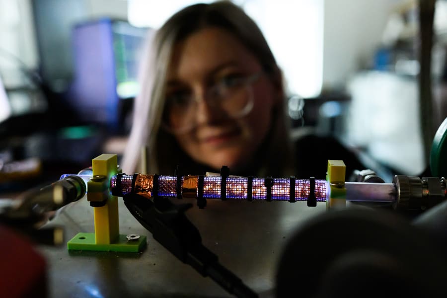McKinney looks at device called a Nanosecond Repetitively Pulsed Dielectric Barrier Discharge (NRP-DBD) packed with beads. This is a kind of plasma reactor. CO2 flows through the system and is being split to produce oxygen. McKinney is studying the influence of packing materials on CO2 conversion. Credit: Gretchen Ertl