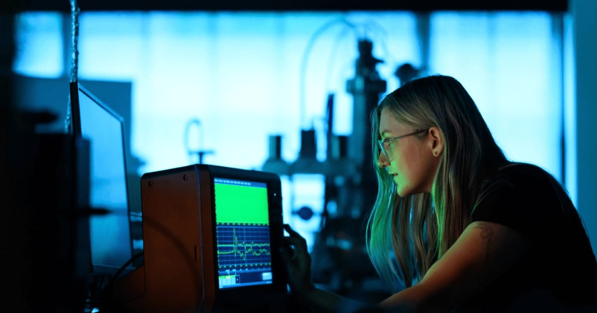 Lanie McKinney examines the voltage and current waveforms for the developed plasma reactor (Cover Image Source: Gretchen Ertl/MIT News)