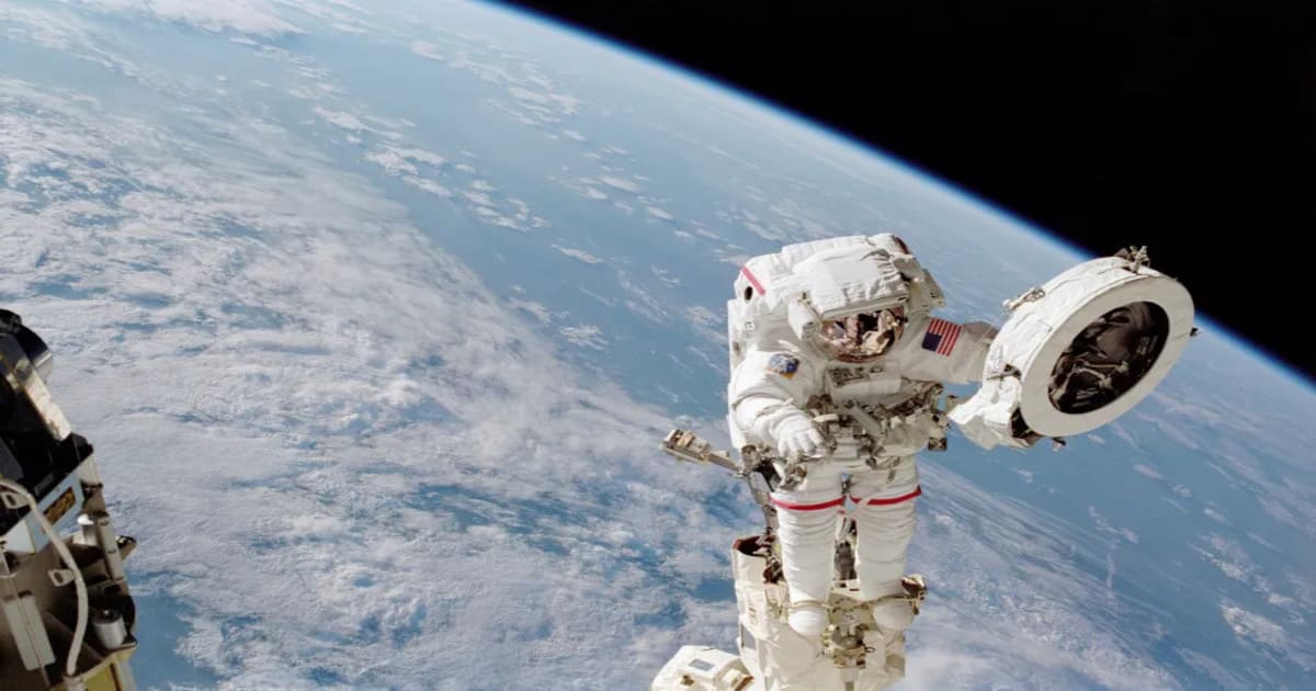 NASA astronaut Franklin R. Chang-Diaz works with a grapple fixture during a June 2002 spacewalk outside the International Space Station. (Image Source: NASA)