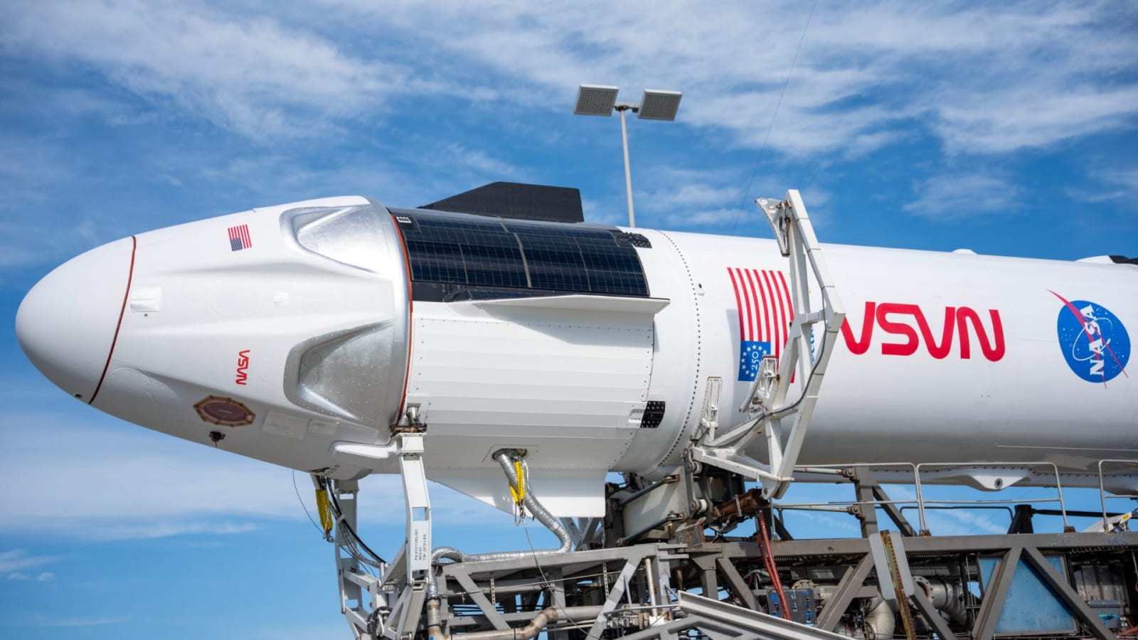 SpaceX Dragon spacecraft and Falcon 9 rocket being moved to the launch pad at Cape Canaveral.
