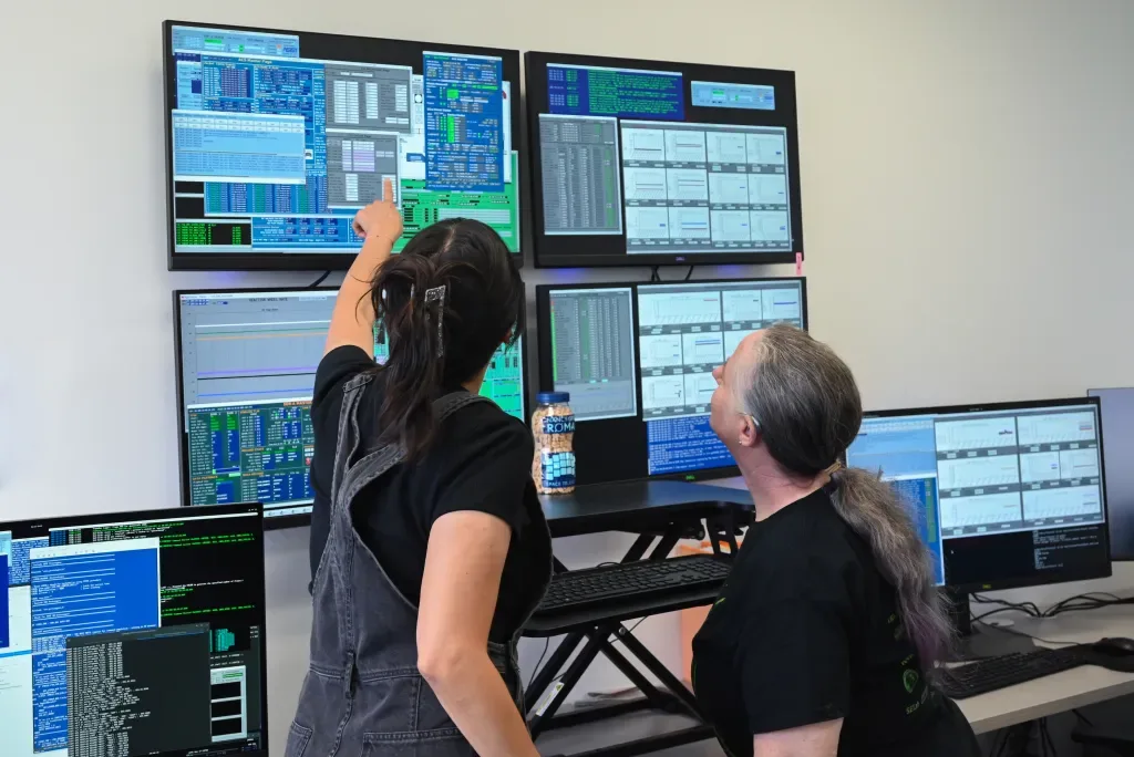 Inside the Roman Coronagraph Commanding Center at IPAC at Caltech, Amelia Nash (left) and Judy Adler (right), Coronagraph Operators, monitor telemetry and wait for the data from the first observation by the coronagraph. Team members have been preparing for this moment, in this very room, for years leading up to launch. Caltech/IPAC – SELab/Isabel Swafford