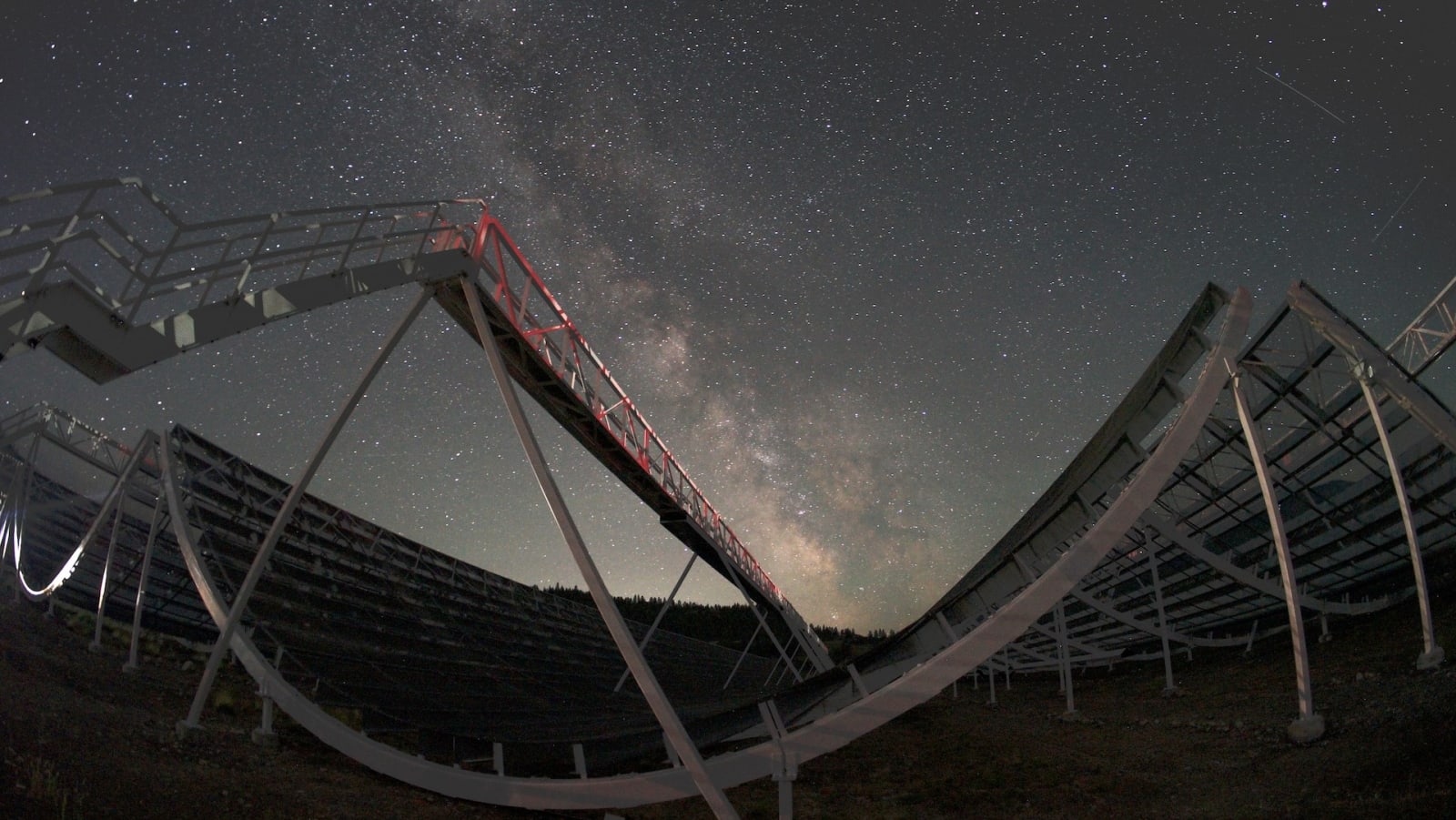 A view of CHIME at night, with the Milky Way in the background. (Image Source: CHIME collaboration | UBC)